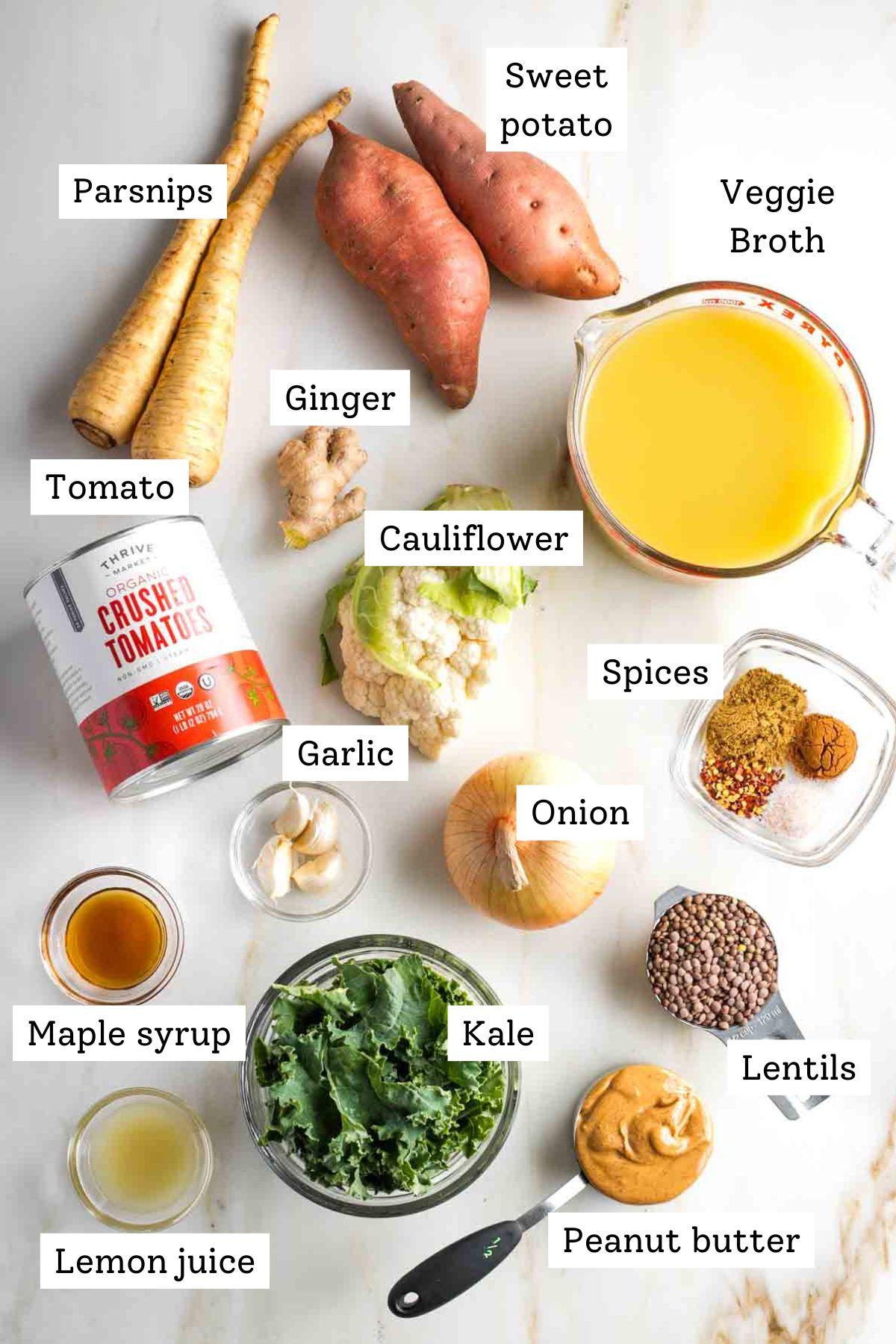 ingredients for vegan sweet potato and peanut soup laid out on a wooden table