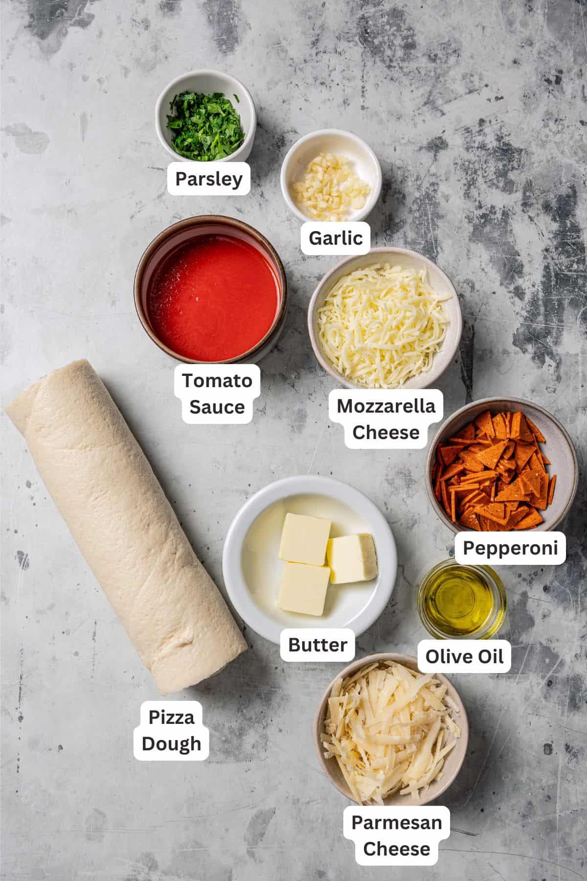 ingredients for pizza rolls laid out on a wooden table