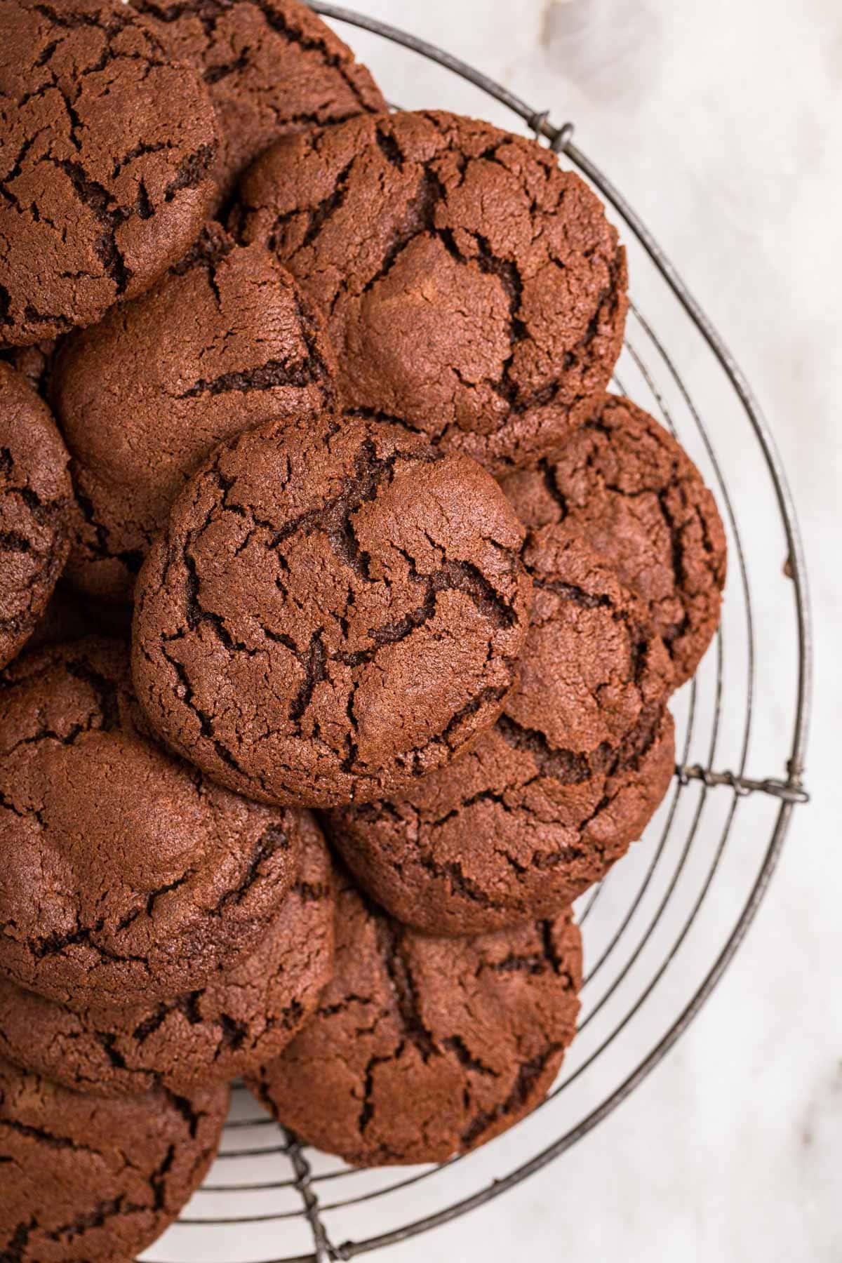 Warm cocoa sugar cookies on a cooling rack, steam gently rising