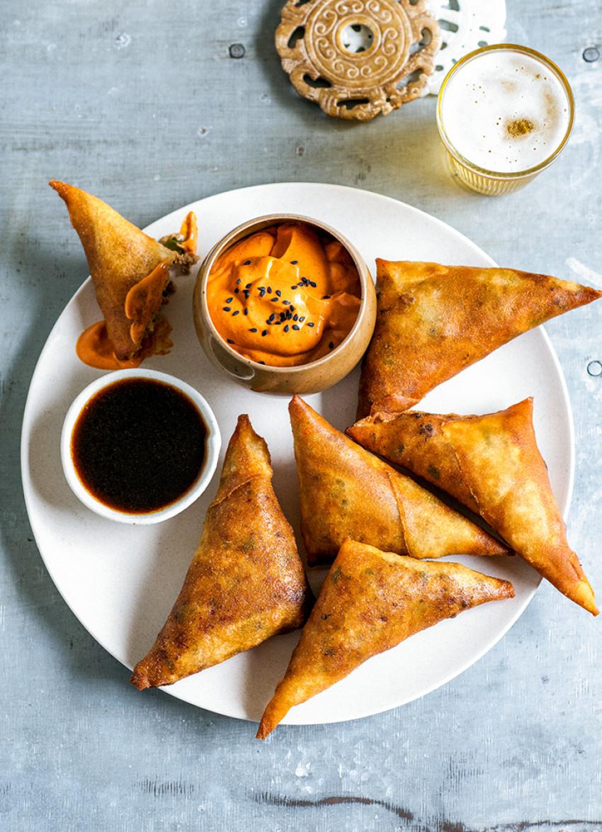 close up shot of fajita chicken samosas with dipping sauce