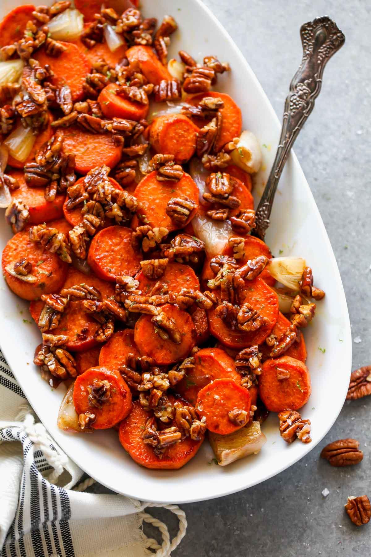 maple glazed roasted sweet potatoes with pecans on a plate