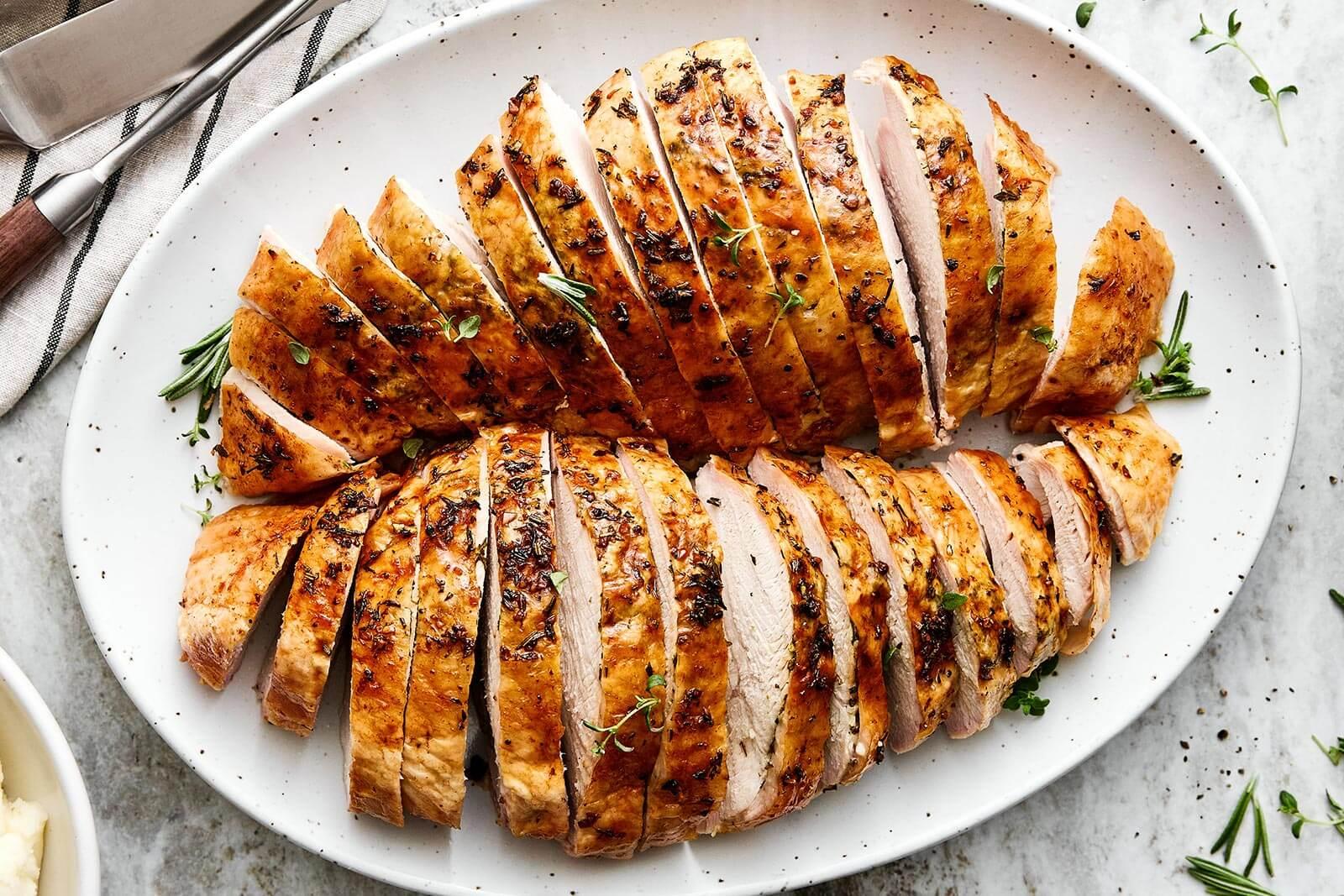 Roasted herb-crusted turkey breast resting on a cutting board, ready to be sliced