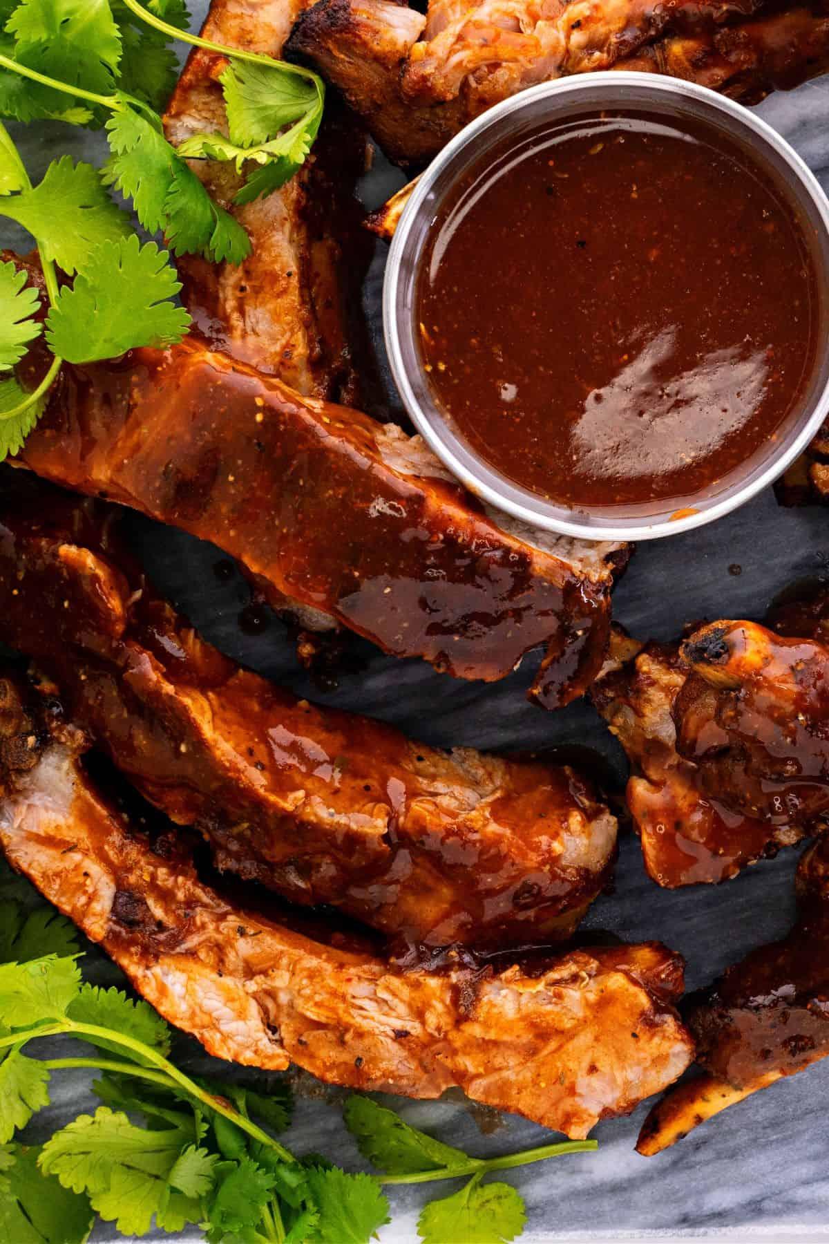 Close-up shot of tender, fall-off-the-bone pressure cooker beef ribs, glistening with BBQ sauce