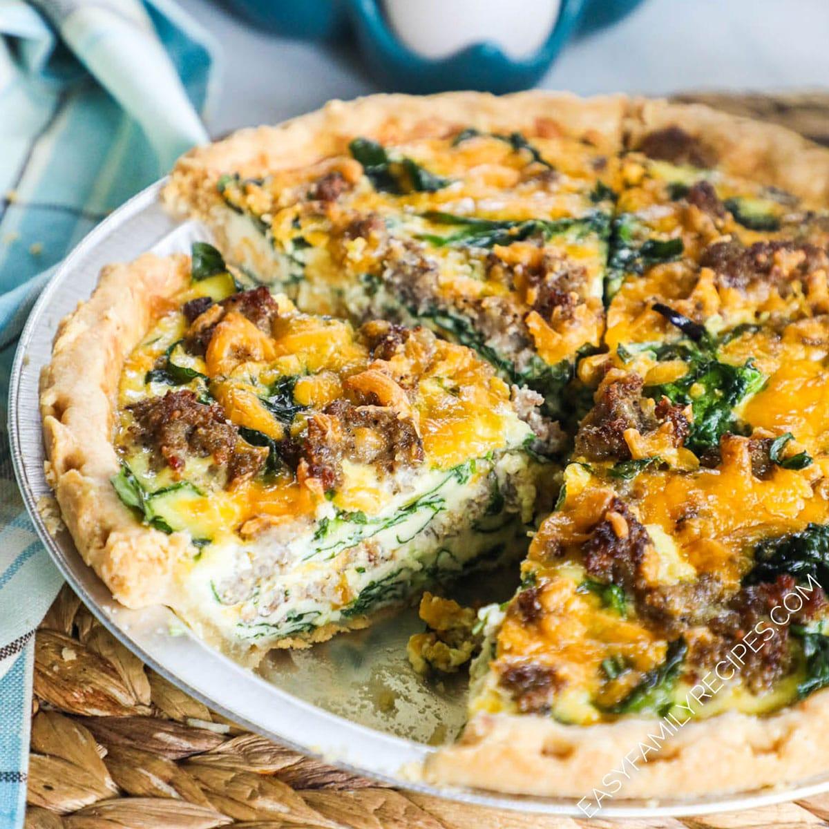 Close-up shot of the layers inside a slice of sausage and spinach quiche