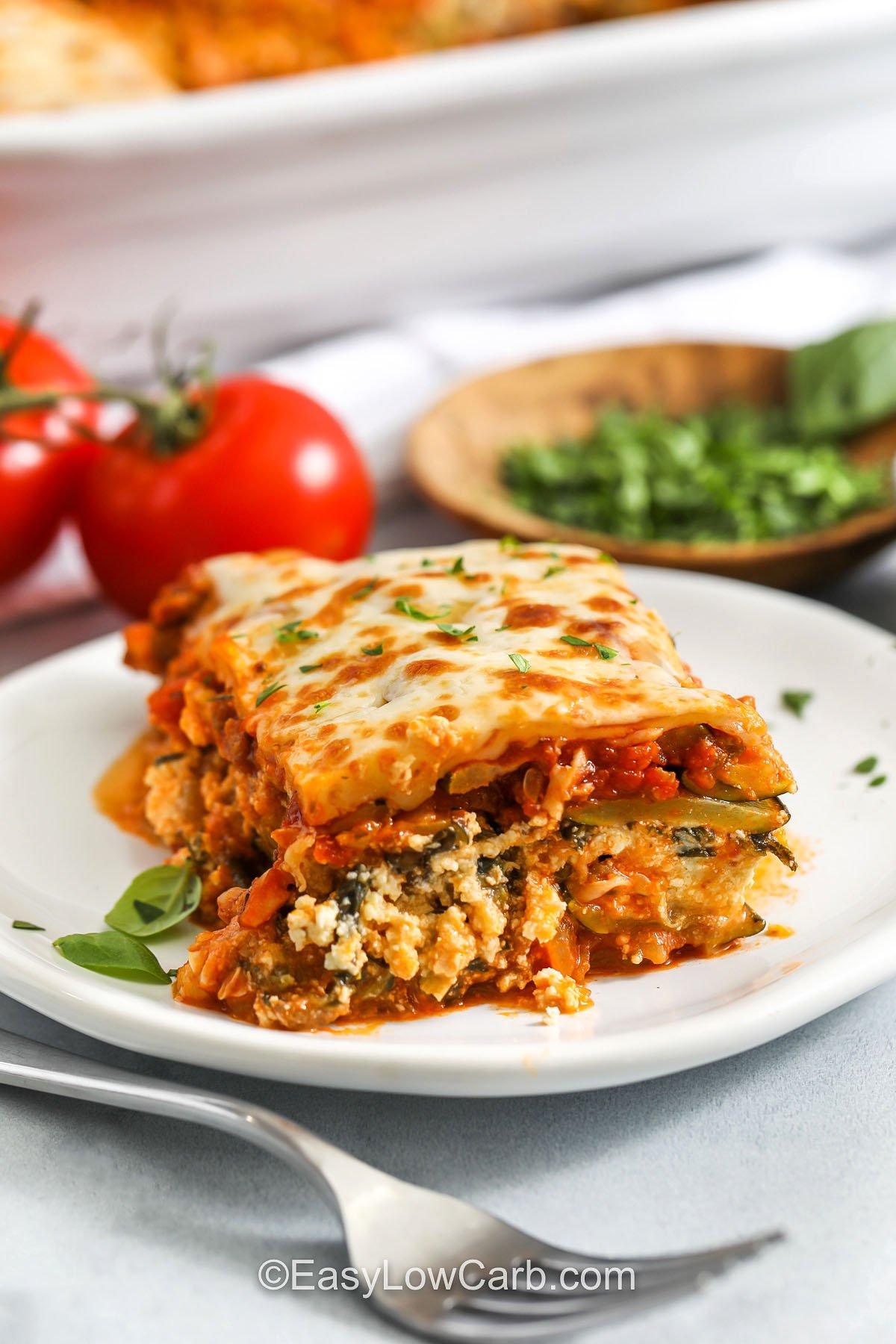 Low-carb zucchini lasagna with mozzarella pearls on a white plate