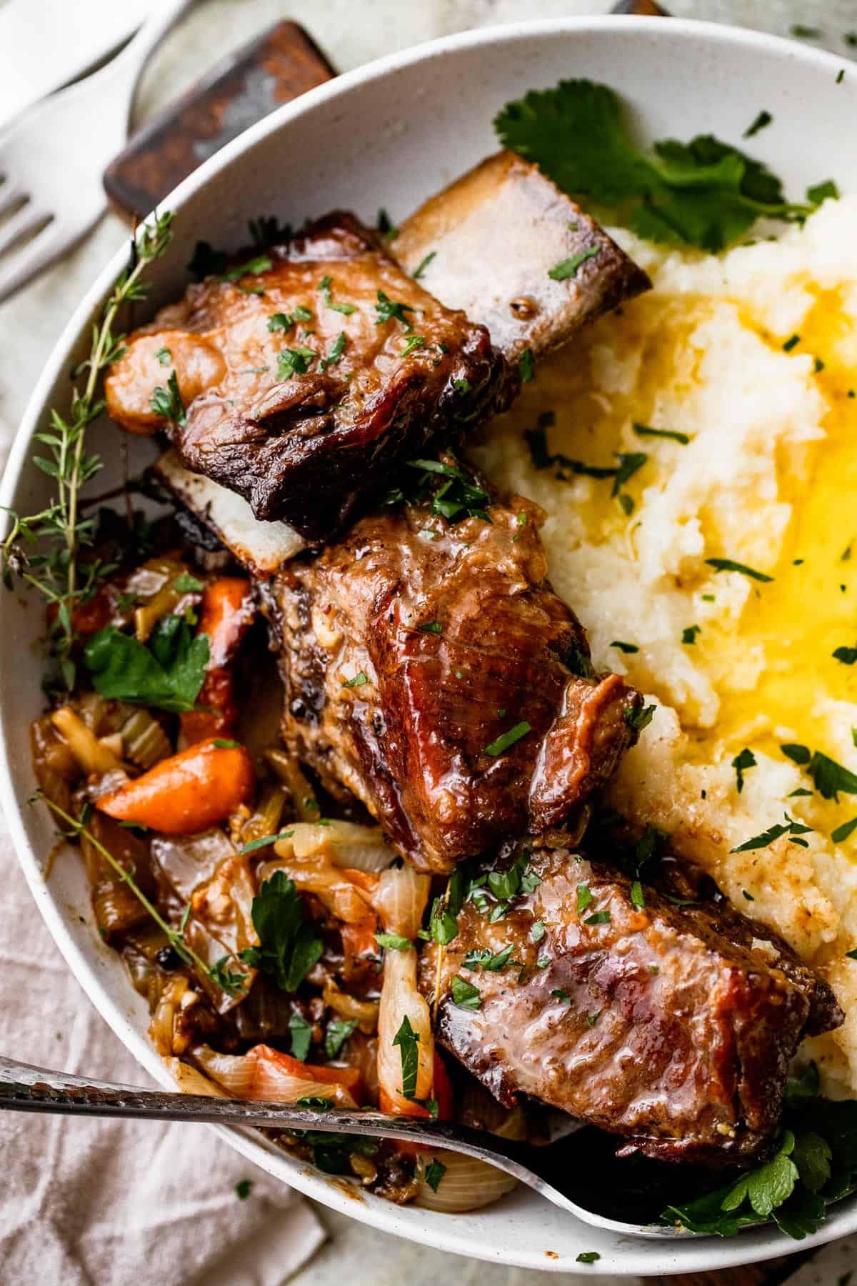 close up shot of beef short ribs slow cooking