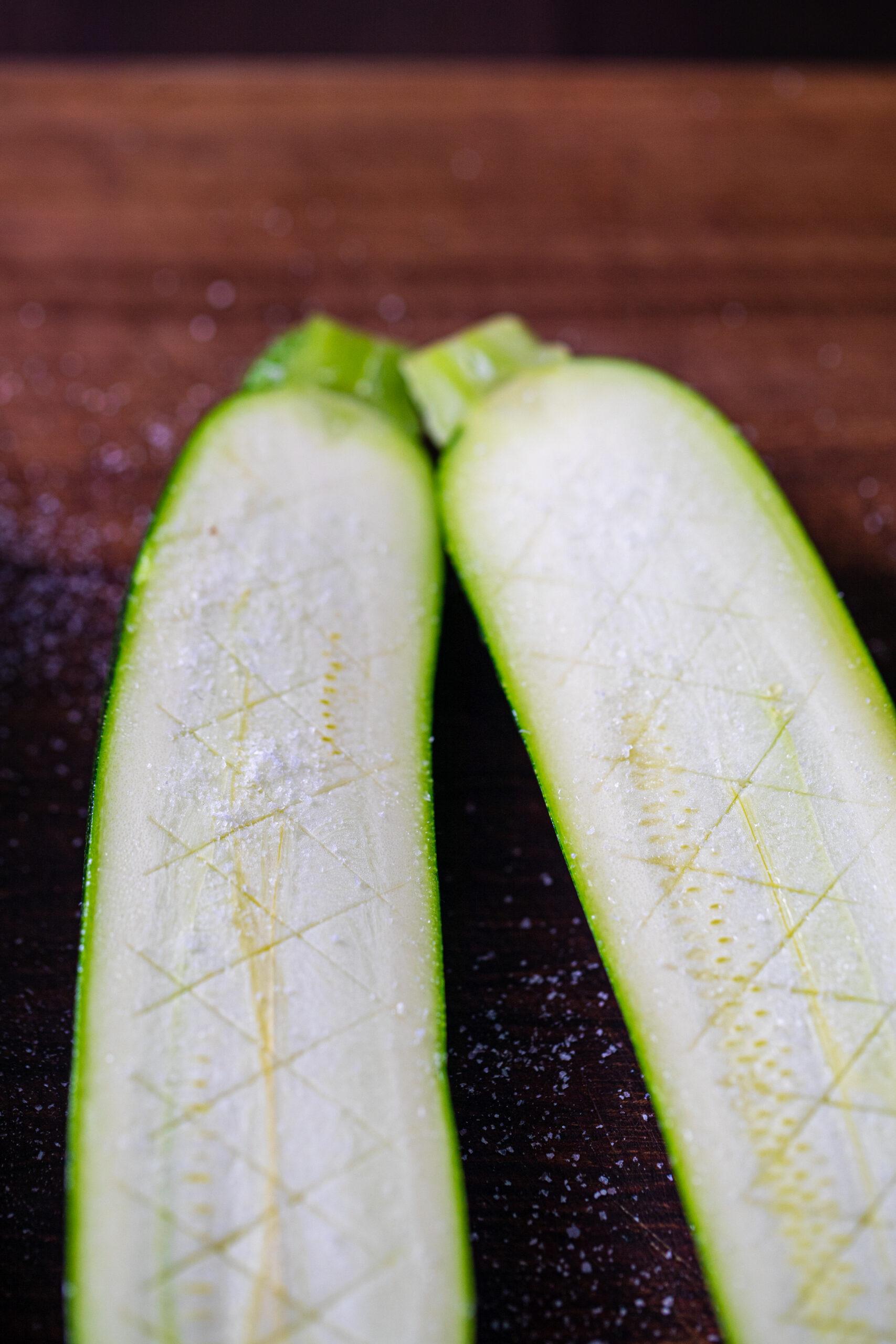 close up view of zucchini being sliced