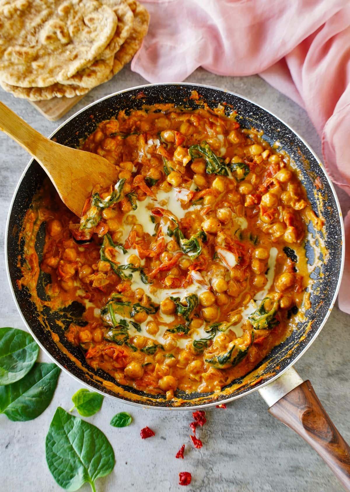 harissa chickpea curry garnished with cilantro and almonds
