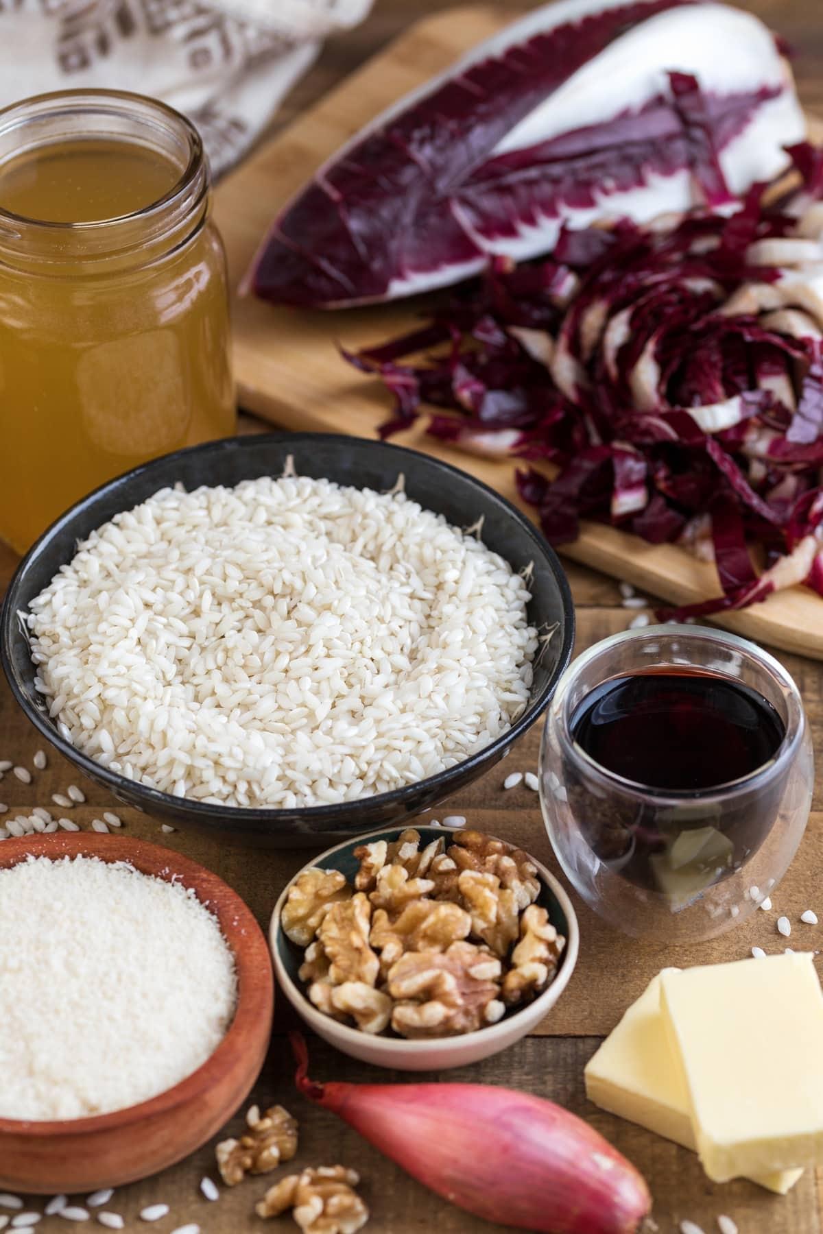 Ingredients for radicchio risotto laid out on a wooden surface