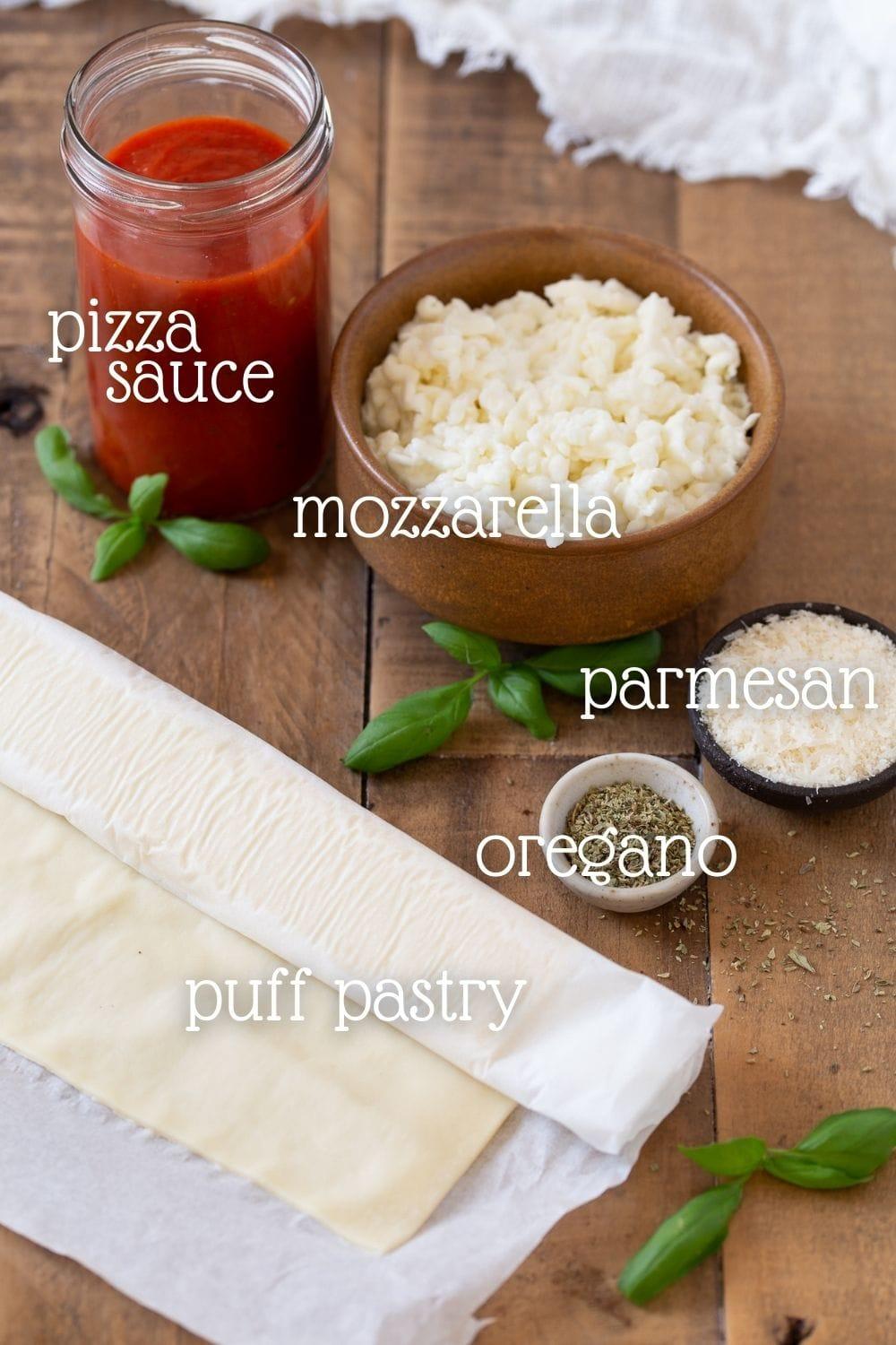 person carefully layering ingredients onto puff pastry for pizza rolls