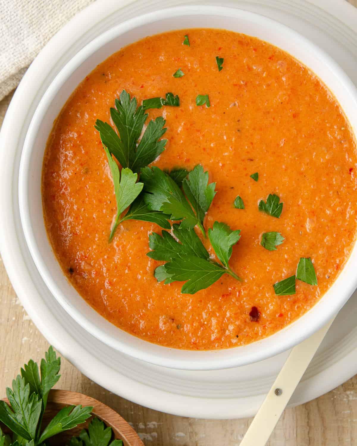Close-up of a steaming bowl of spicy sausage and pepper soup