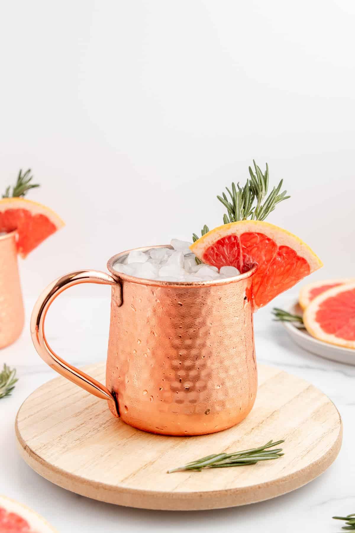 finished Grapefruit Moscow Mule in a copper mug, garnished with grapefruit slice and mint sprig