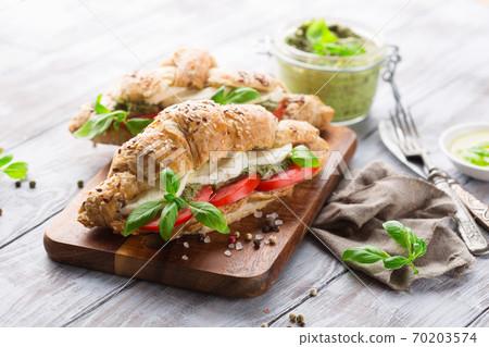 tomato mozzarella croissants on a rustic wooden board
