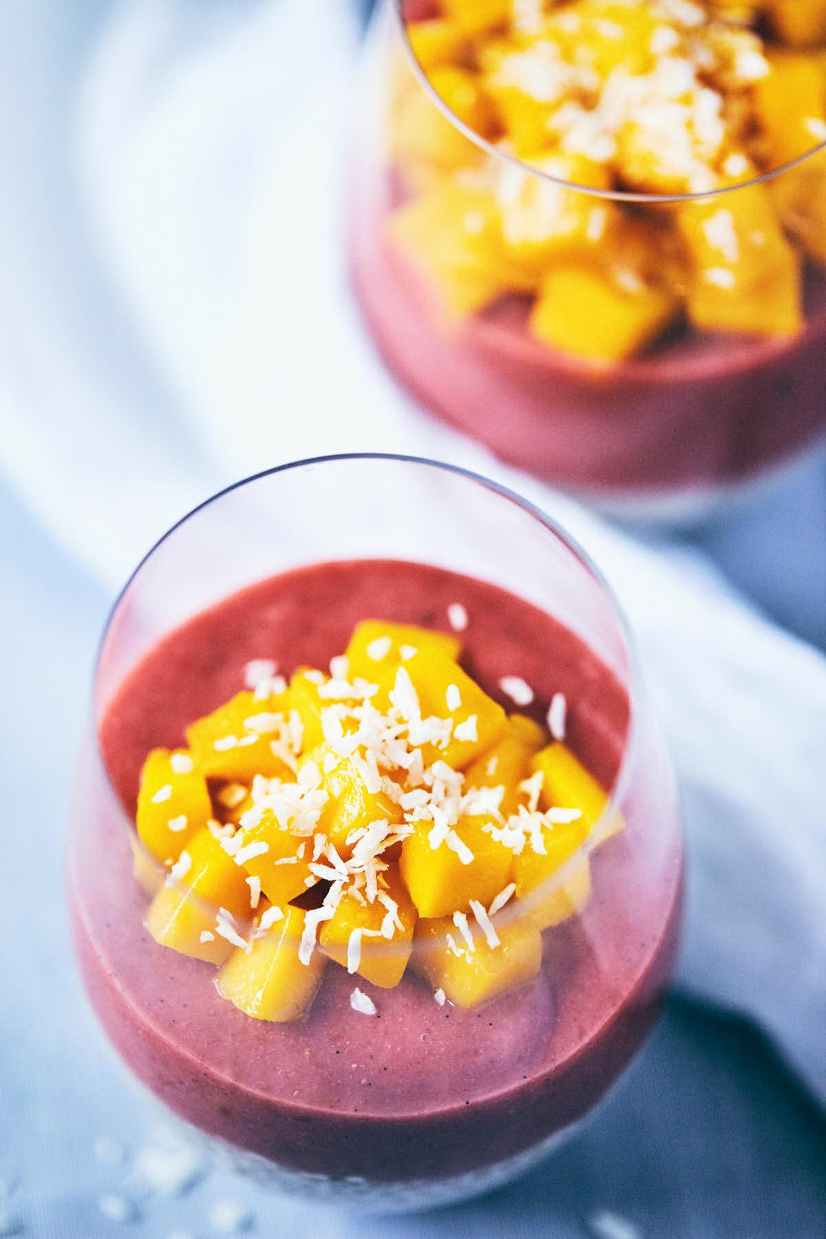 layered guava passionfruit chia seed pudding in a glass