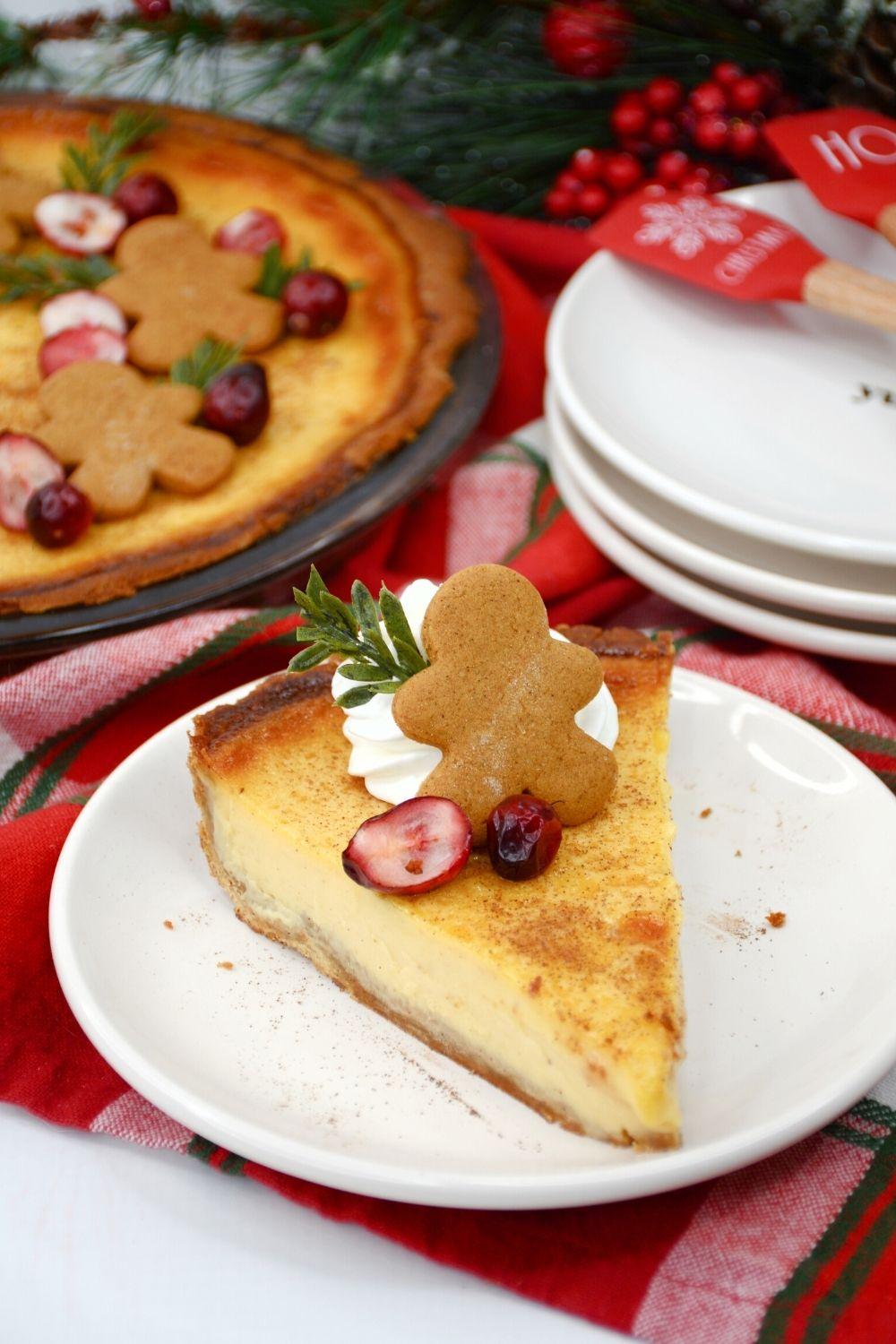 A beautifully garnished eggnog pie slice on a festive plate with a creamy custard filling, holiday decorations in the background