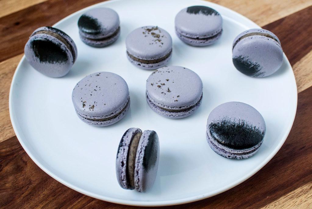 Close-up shot of a single kimchi macaron with black sesame filling