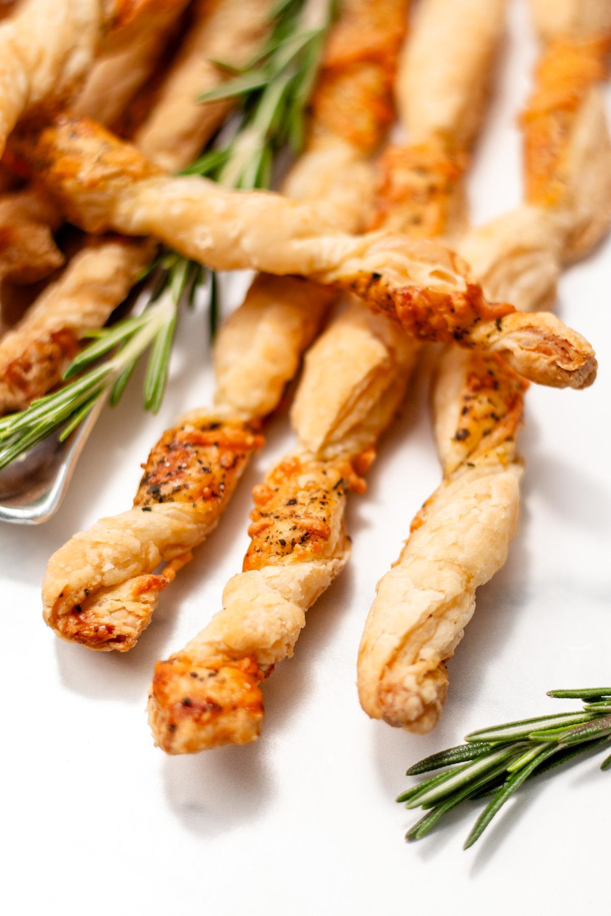 close up of golden puff pastry twists with parmesan cheese