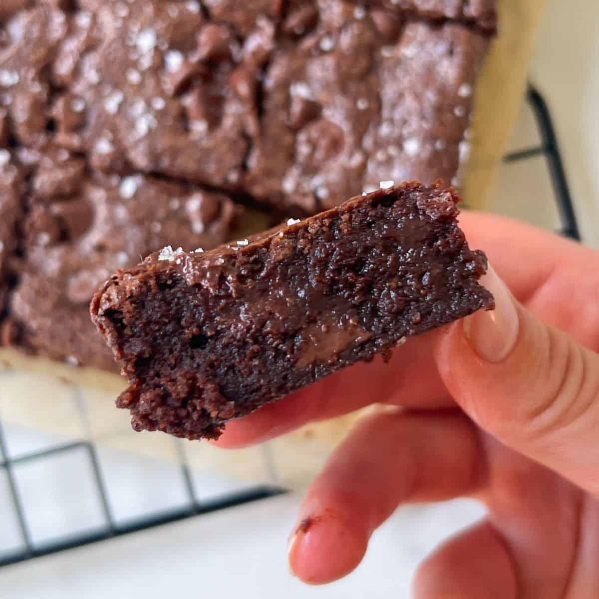 Espresso brownies arranged on a platter, garnished with chocolate shavings and sea salt