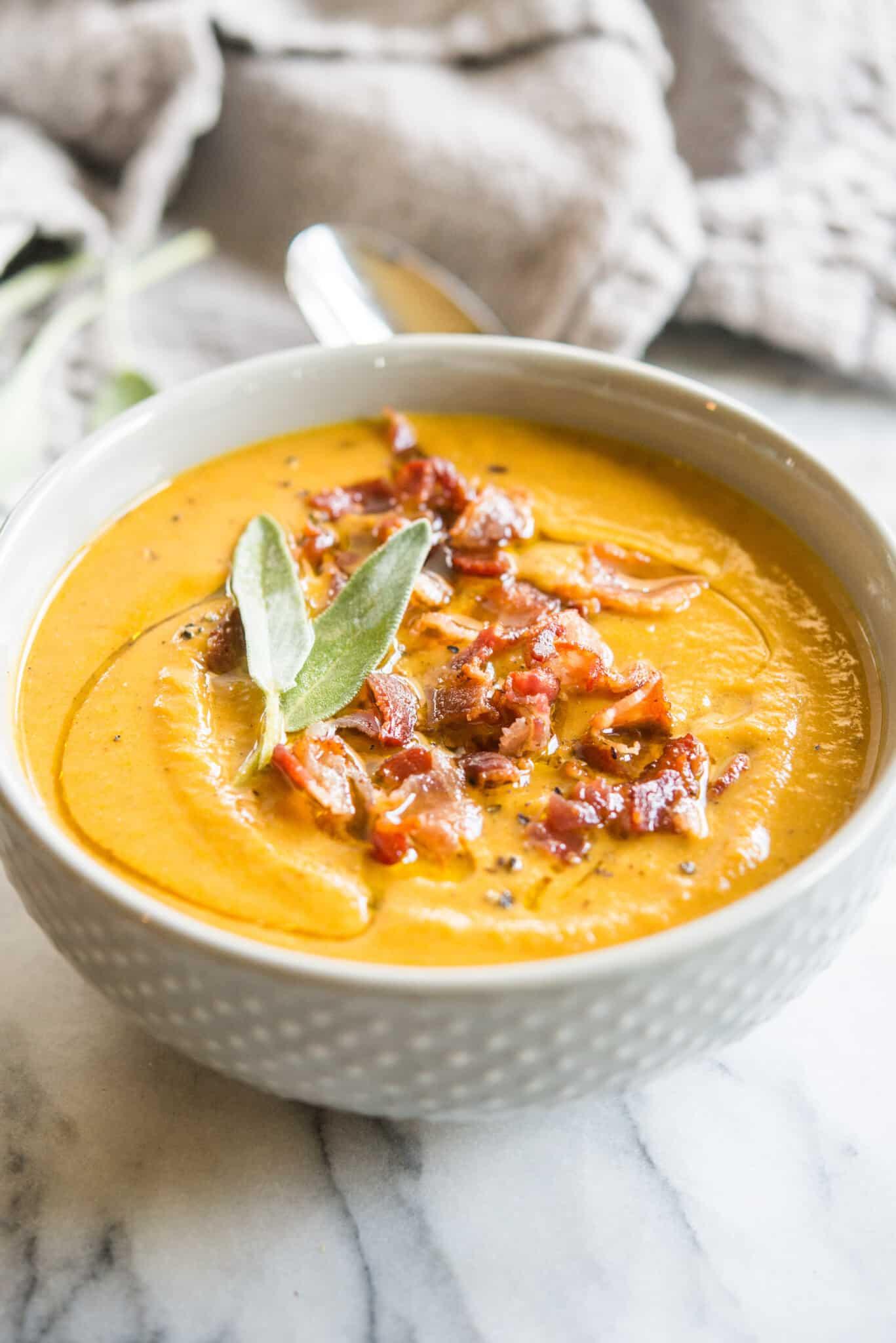 A rustic kitchen scene with a large pot of pumpkin soup simmering on the stovetop.
