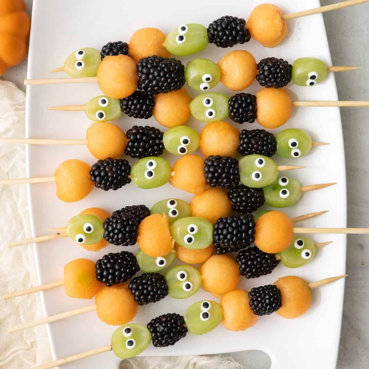 fruit skewers with halloween decorations