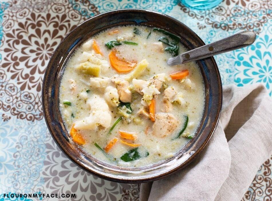 Close-up shot of the stew, showcasing the various vegetables and creamy broth with steam rising