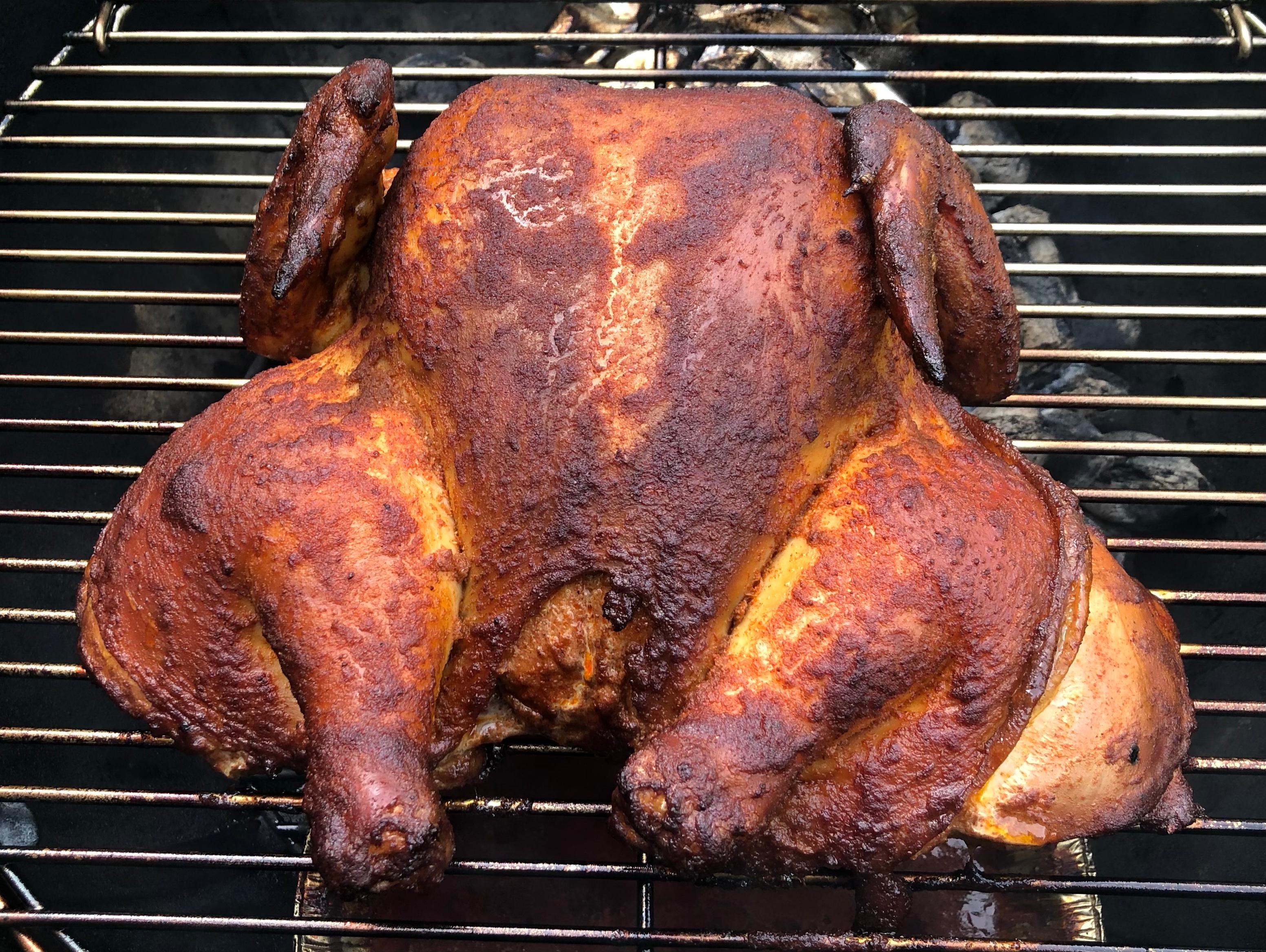 Smoking a whole chicken on a charcoal smoker