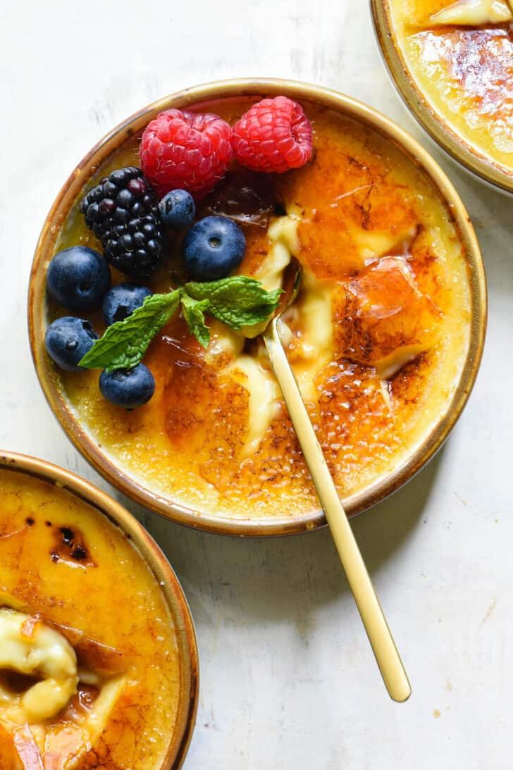 Close-up shot of vanilla bean crème brûlée with caramel sauce