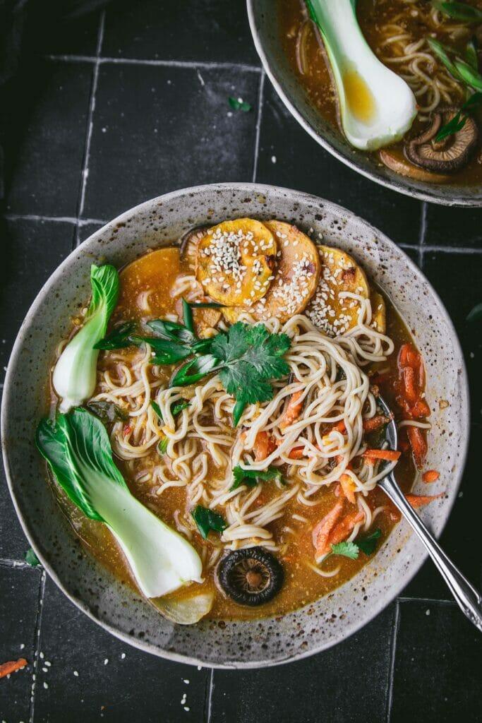 Close up shot of creamy sesame ramen with roasted vegetables