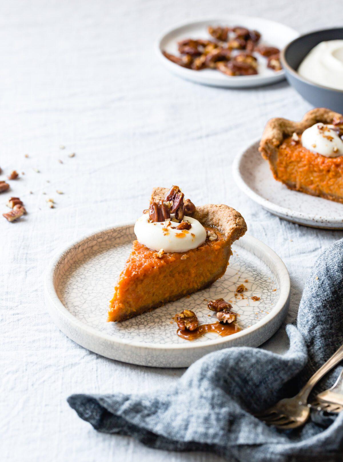 Steaming mug of sweet potato pie hot chocolate topped with pecans