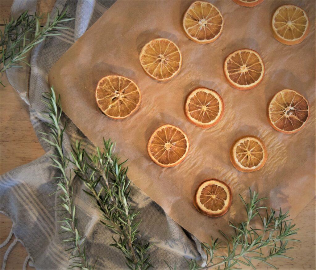 close up shot of rosemary and orange gingerbread rounds on a rustic wooden surface