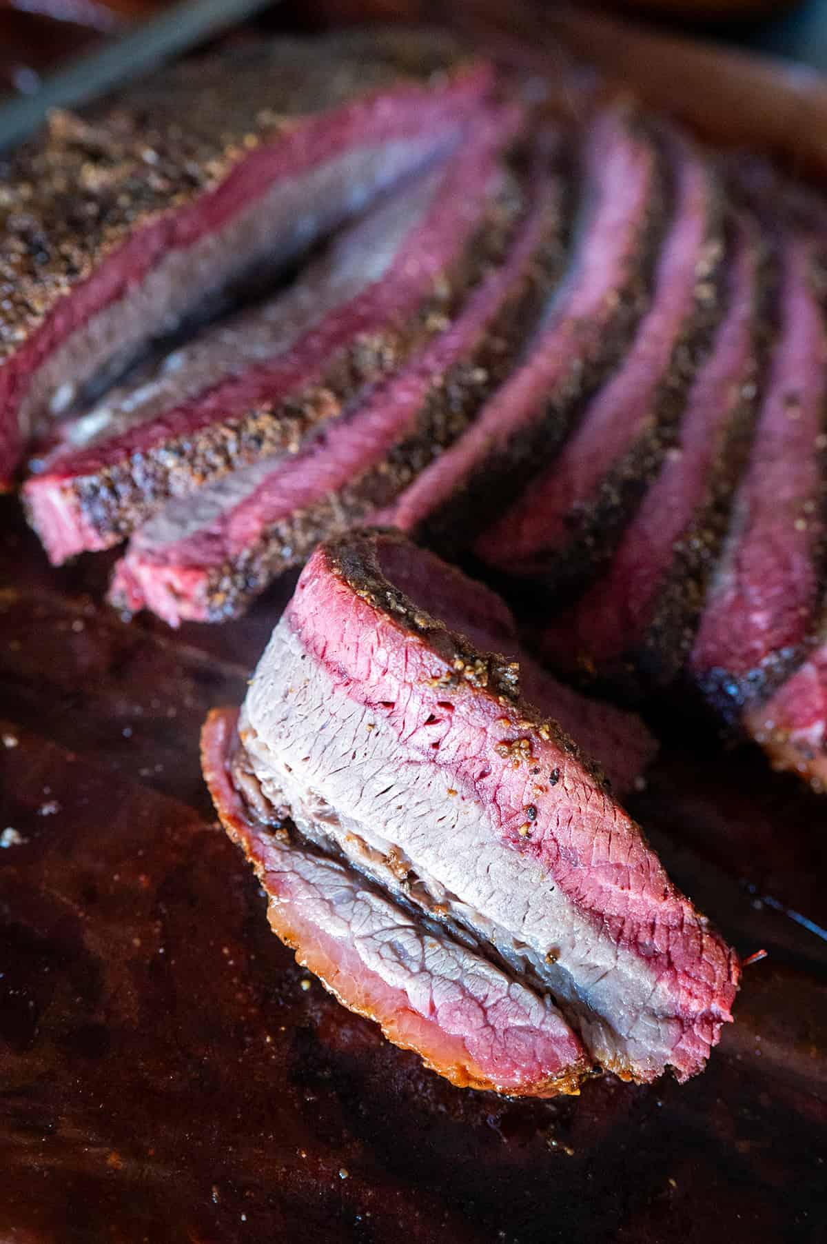 close-up of a slice of brisket showing a vibrant smoke ring