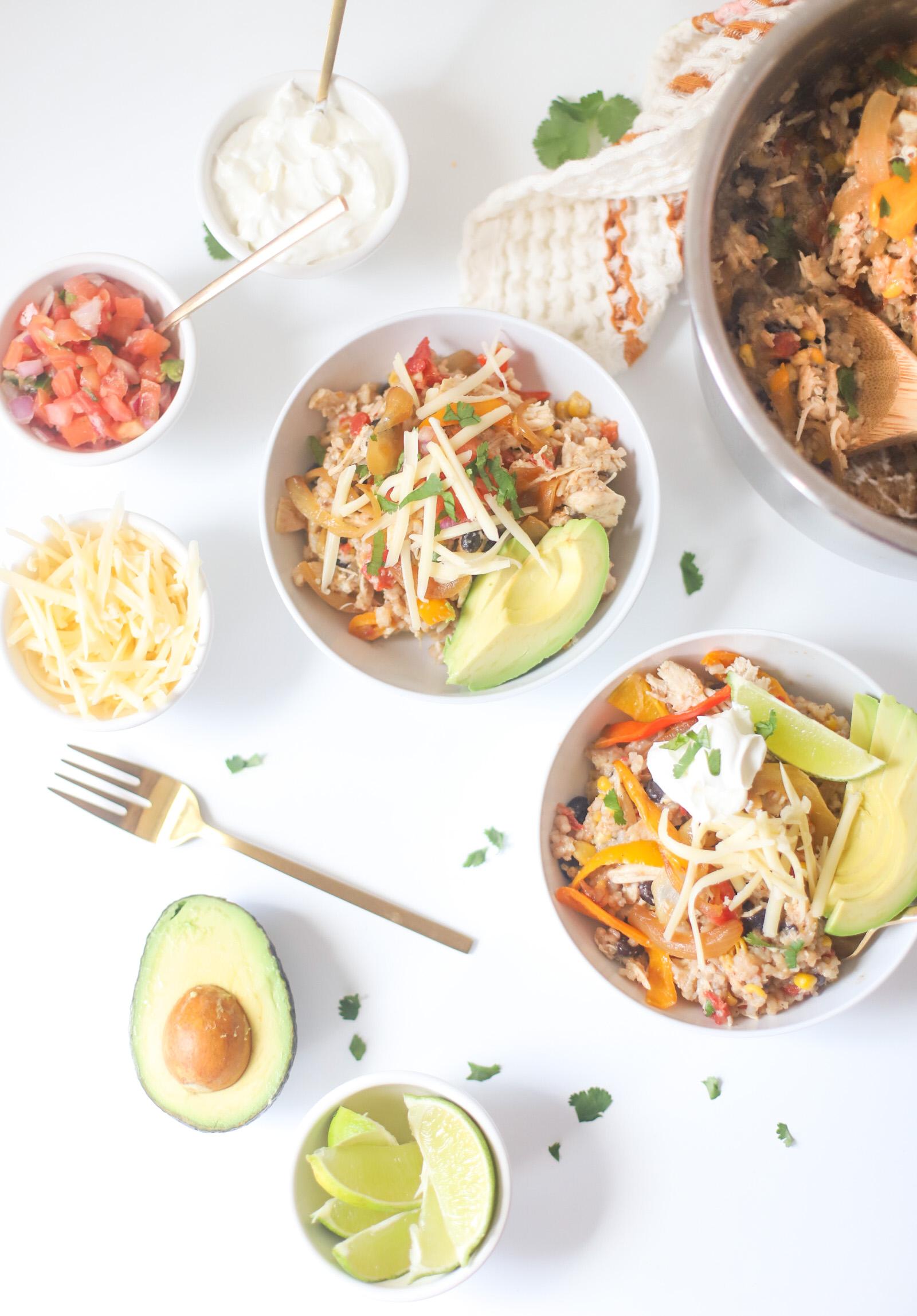 Overhead shot of several Instant Pot Chicken Fajita Rice Bowls topped with various toppings