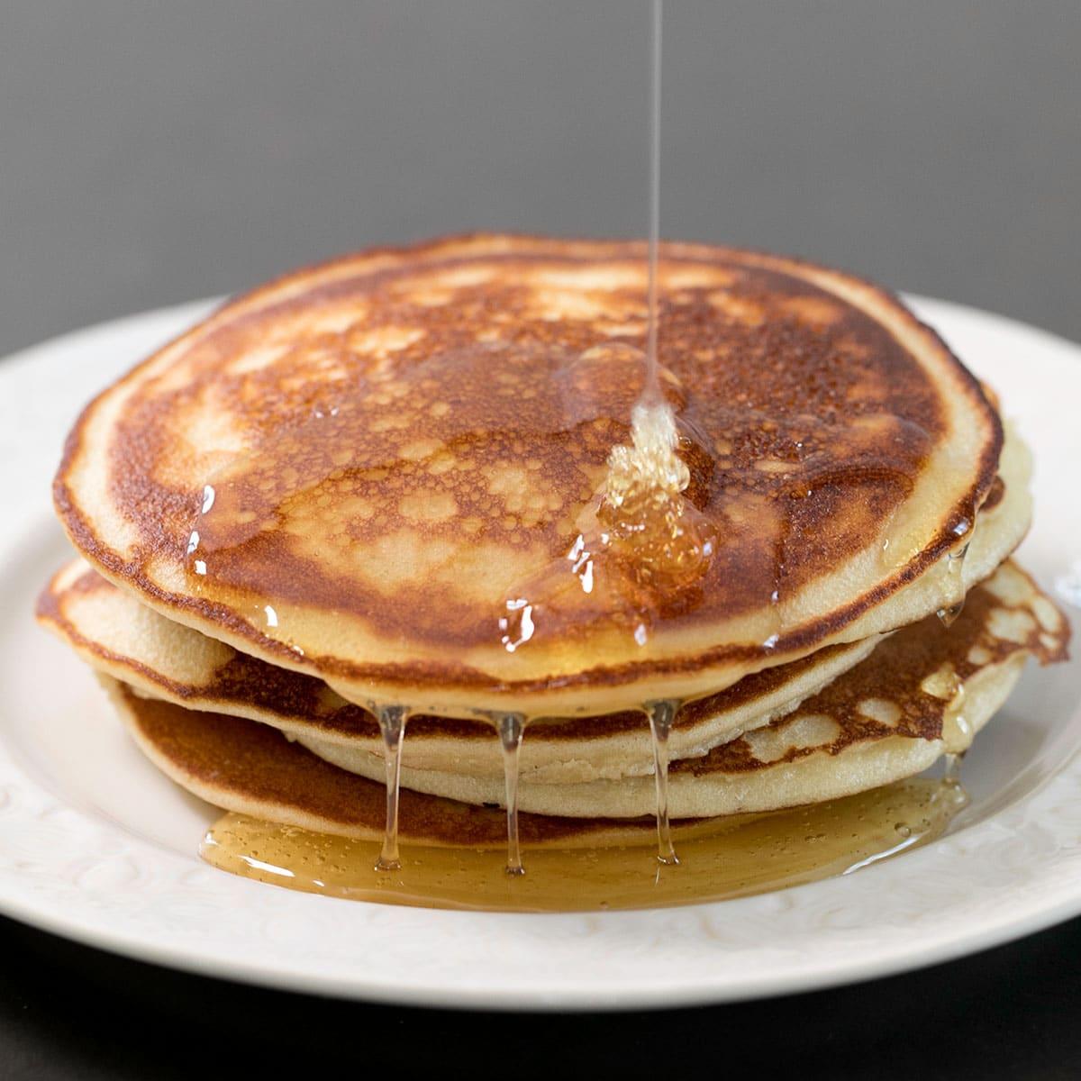 close-up shot of freshly cooked paleo pancakes stacked on a plate