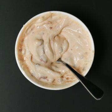 a close-up shot of chipotle tzatziki being swirled with a spoon