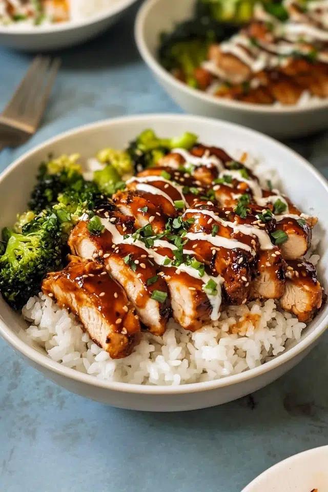 close up of sticky chicken rice bowls with green onions and sesame seeds