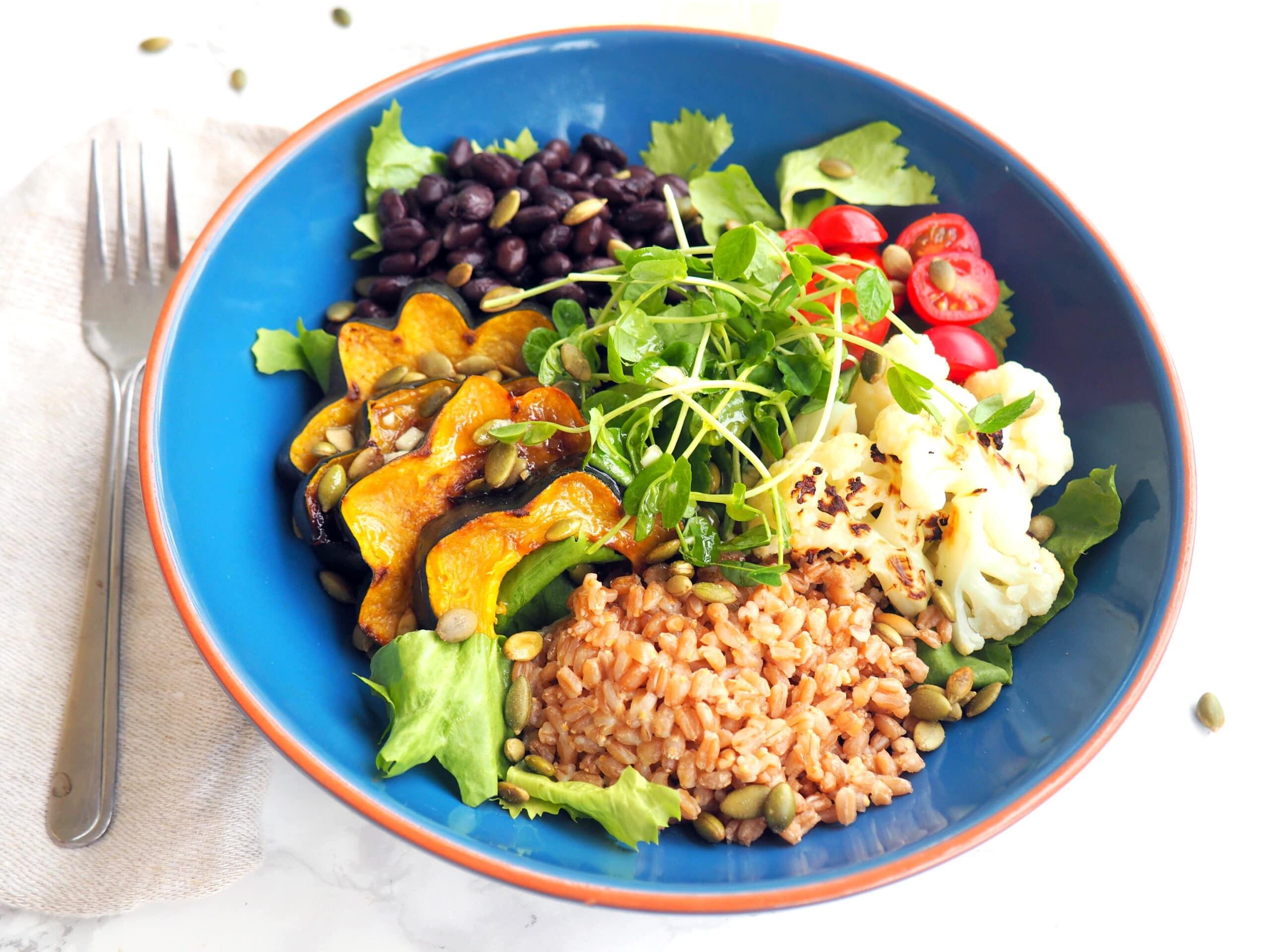 overhead shot of a fully assembled vegan power bowl, showcasing the vibrant colors of the ingredients
