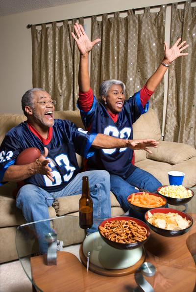 people watching a game with a bowl of chili