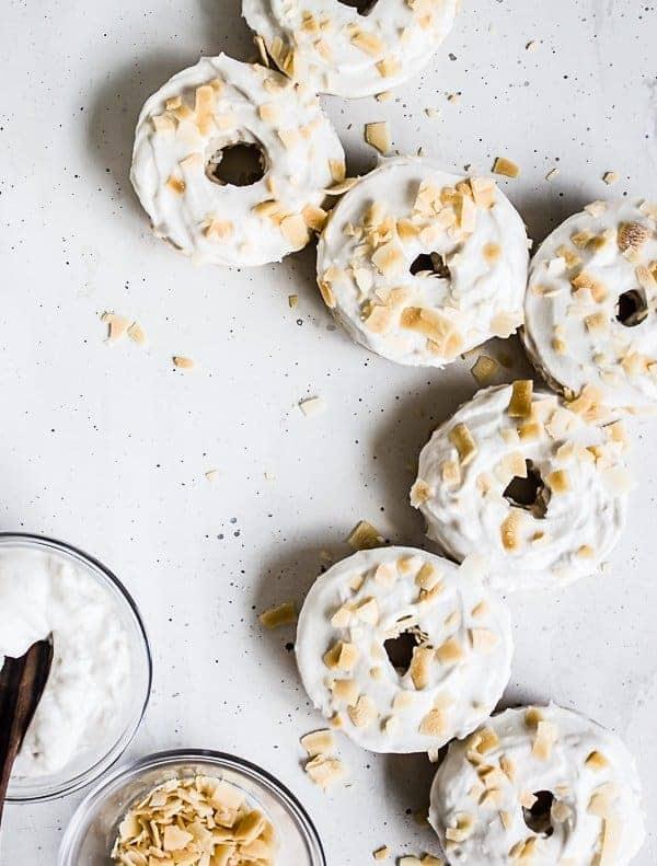 coconut cream pie donuts with coconut flakes, decorated beautifully