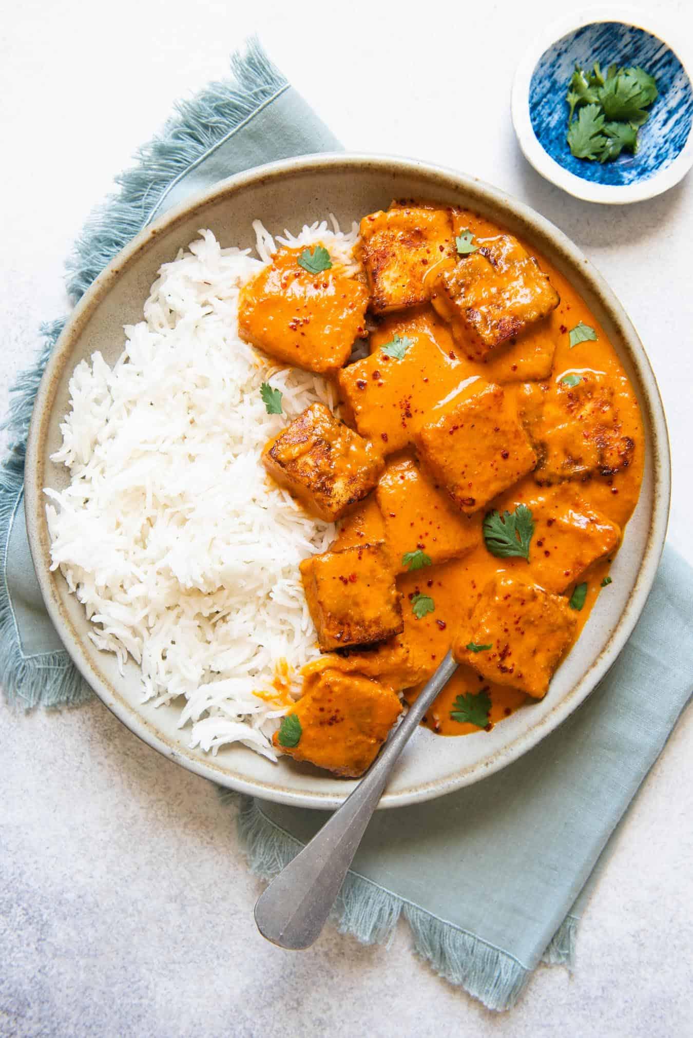 A bowl of paneer tikka marinade with spices and yogurt