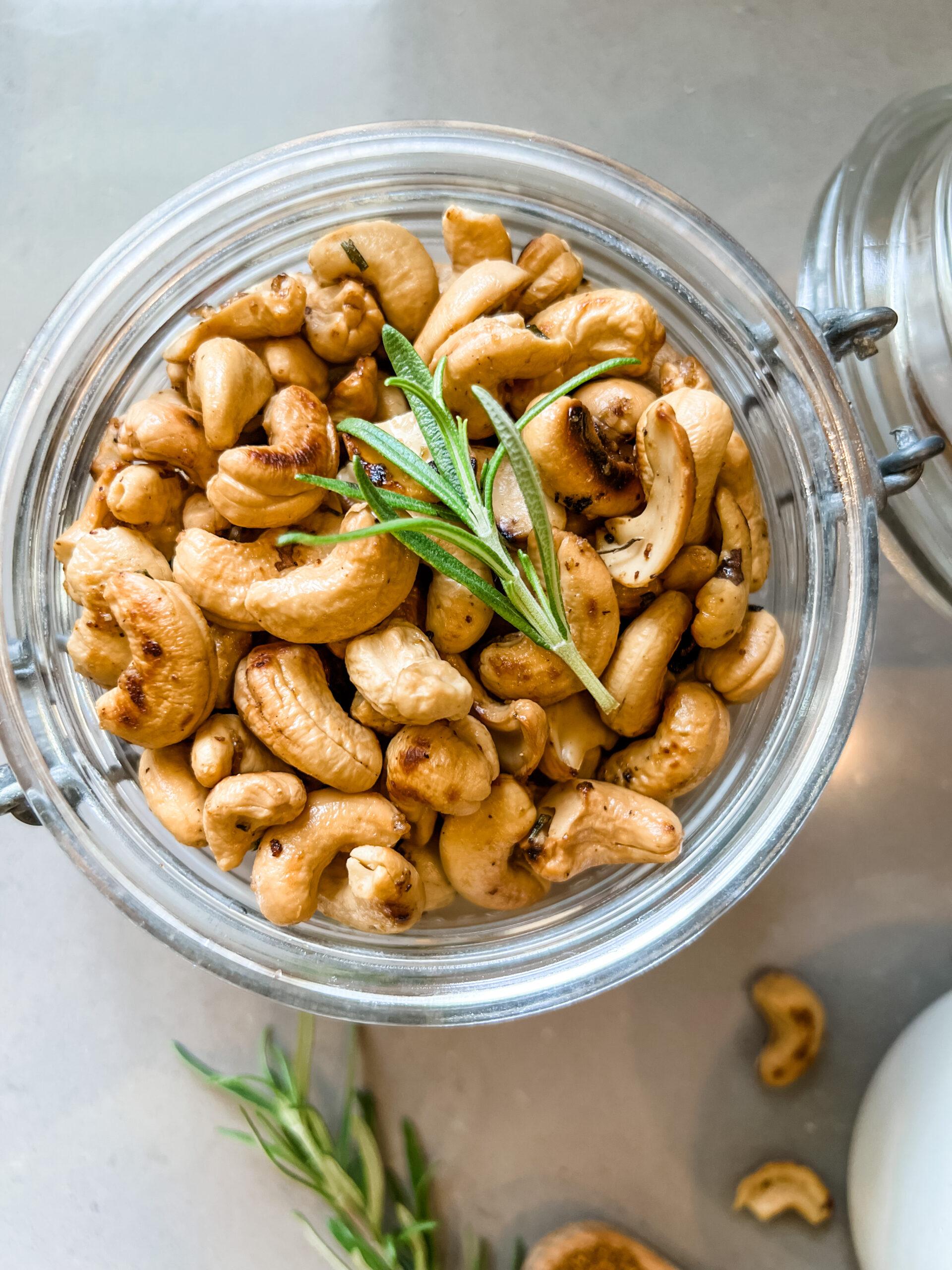close-up shot of a single Rosemary Parmesan Cashew, highlighting the texture and herb coating