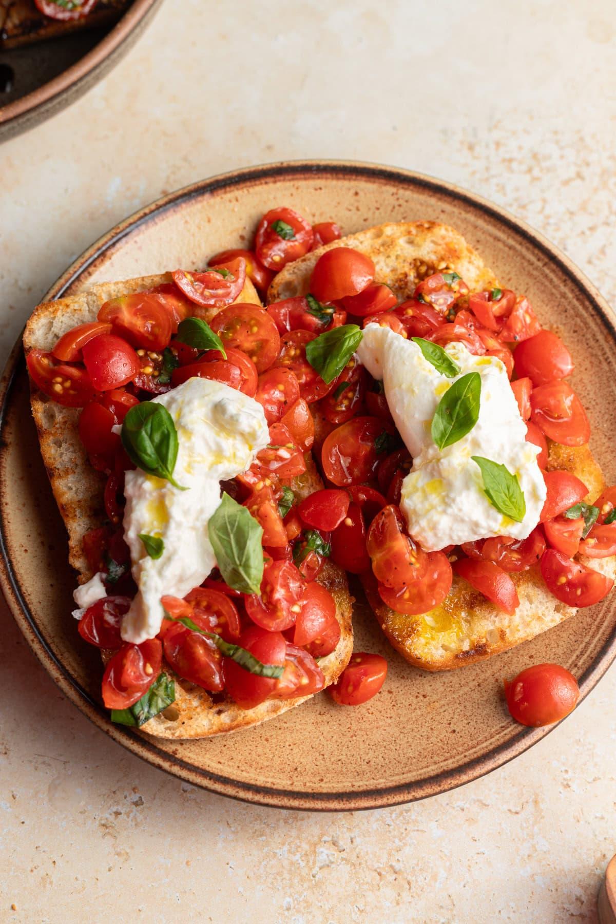 a plate of barley and tomato bruschetta served outdoors