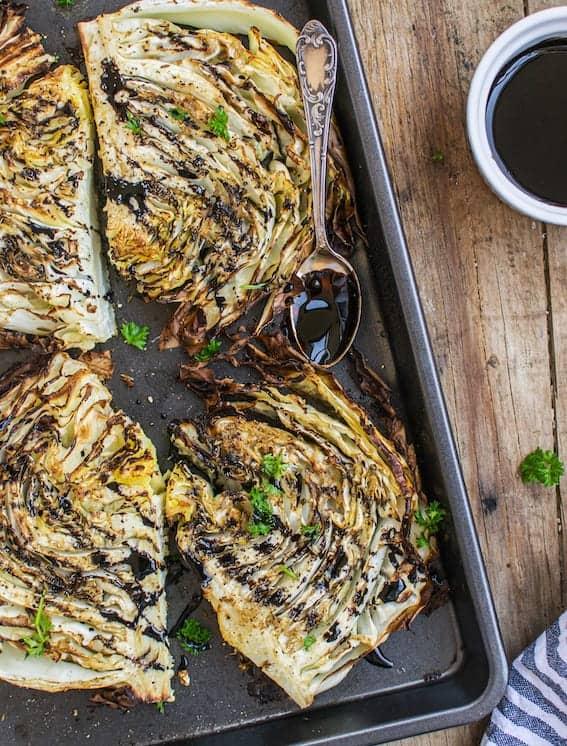 roasted cabbage with balsamic glaze and rosemary on a baking sheet