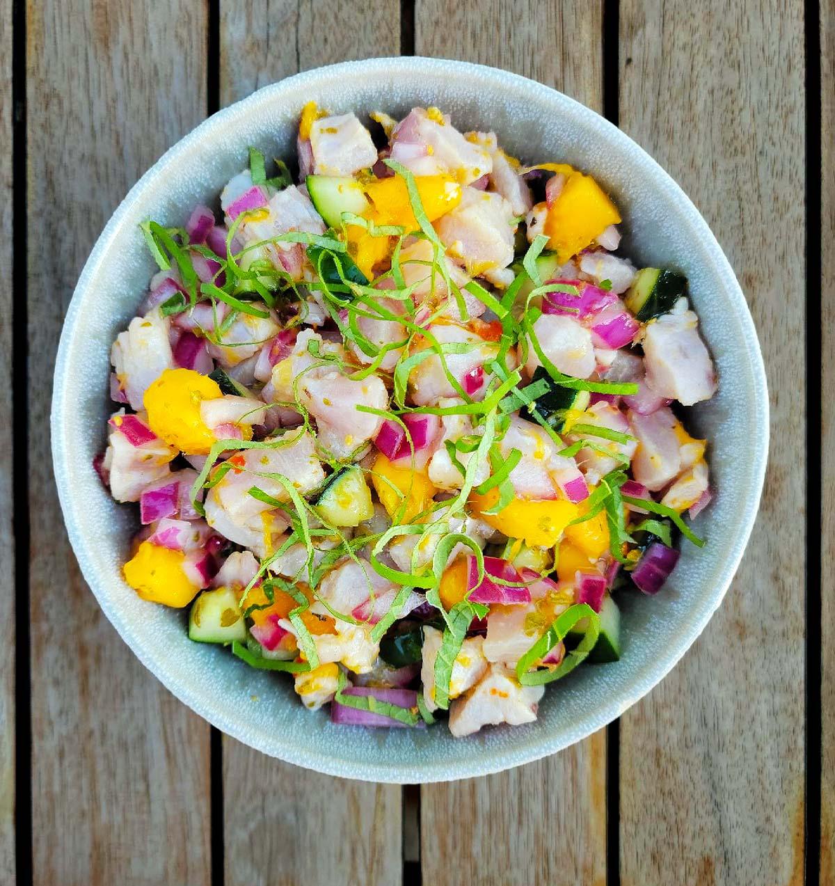 overhead shot of green apple jalapeno mahi-mahi ceviche in a glass bowl