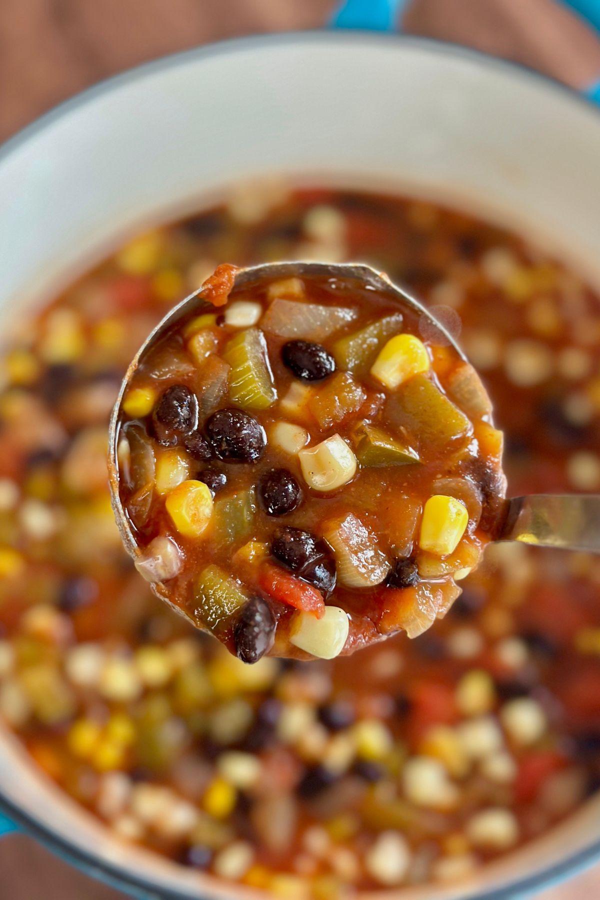 close-up of black bean and corn soup simmering in a pot