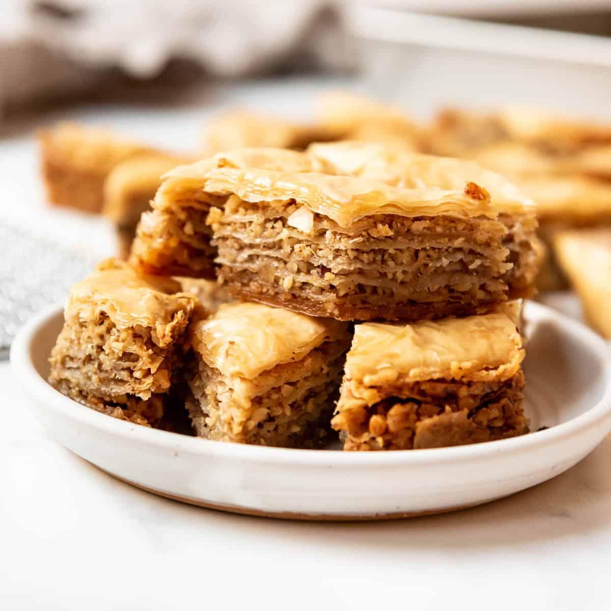 Close-up of apricot and clove walnut baklava on a serving plate.