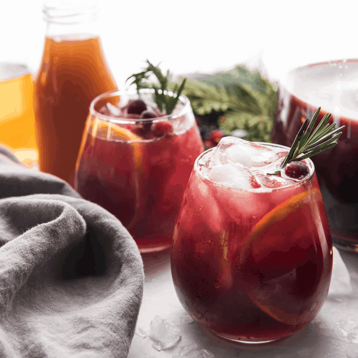 Close-up of hands pouring ruby sangria into a glass, cozy holiday setting