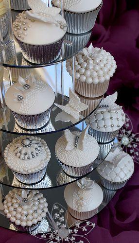 overhead shot of multiple lace and pearl cupcakes on display