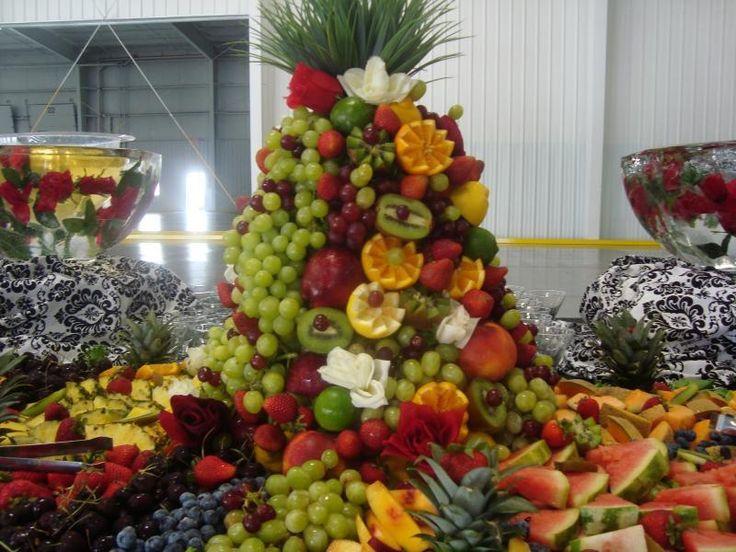 a stunning fruit platter resembling a mountain landscape with various colorful fruits