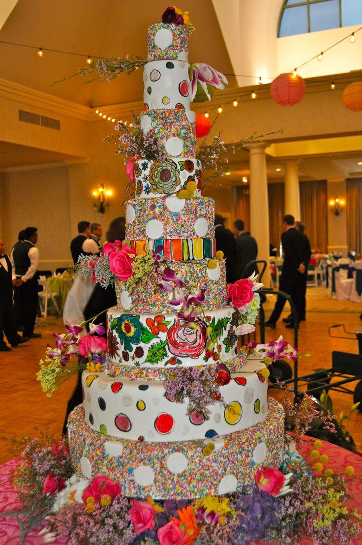 Extravagant multi-tiered birthday cake with colorful decorations
