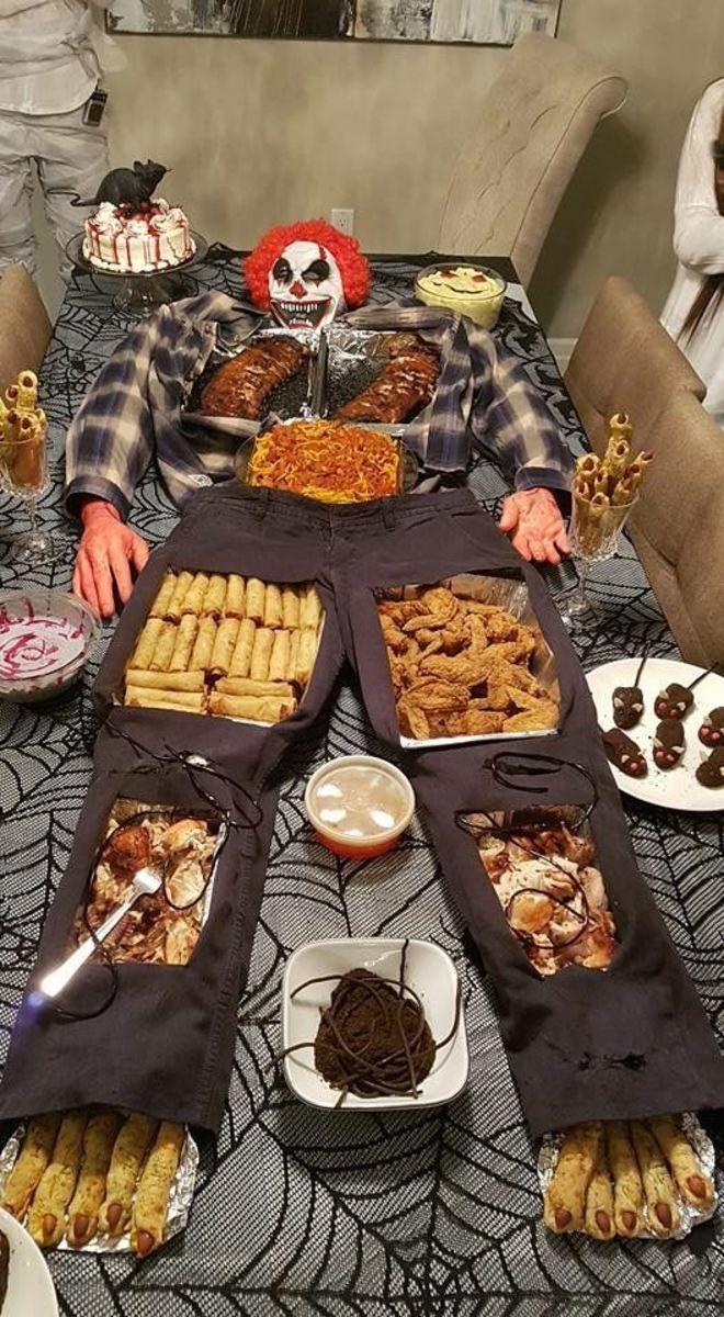 halloween food buffet table with spooky themed dishes